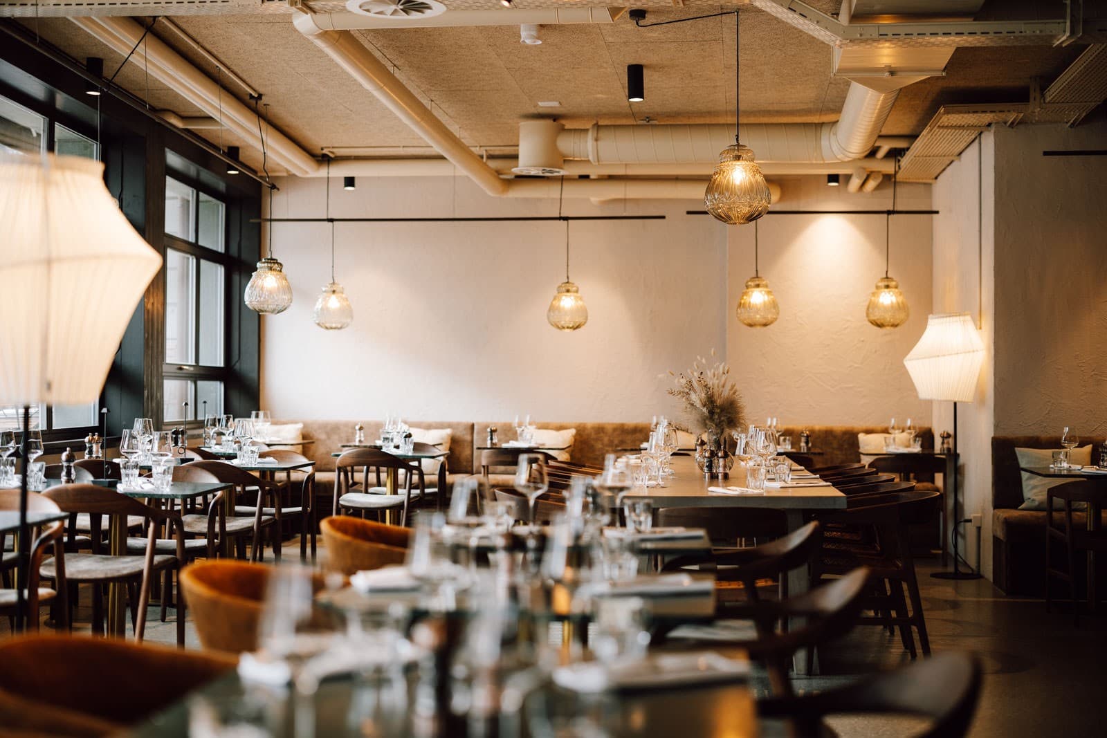 Olive restaurant — spacious dining hall with pendant lights